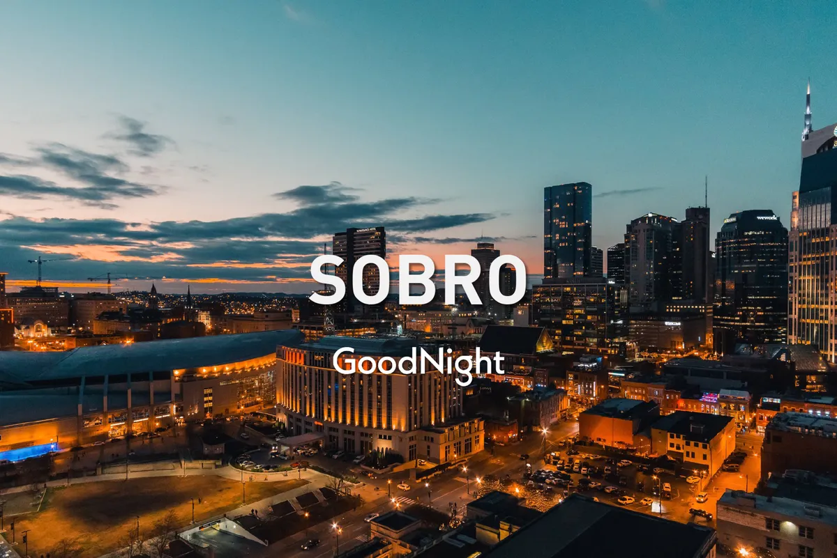 A stunning panoramic view of the Nashville city skyline at sunset, with illuminated buildings and a colorful sky, evoking the vibrant nightlife and excitement of city exploration after dark.