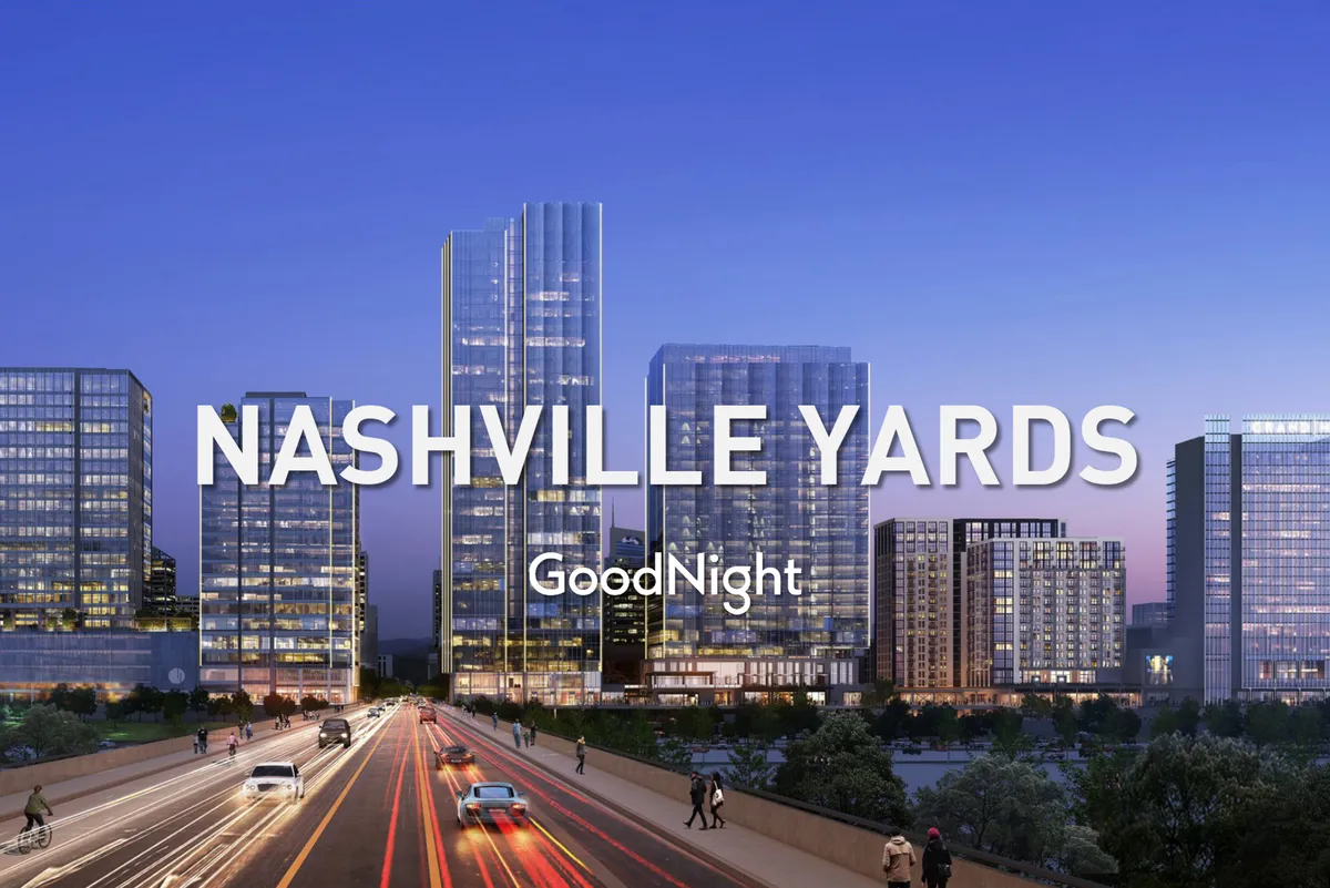 A dynamic cityscape featuring Nashville’s illuminated skyscrapers, a bustling roadway, and vibrant city lights. The image exudes energy and activity, reflecting the convenience and excitement of being at the heart of a thriving business district.